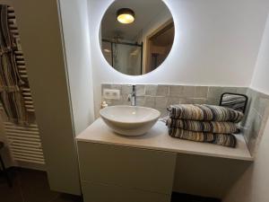 a bathroom with a white sink and a mirror at Casa Sandra Elisa - Studio aan water in Maasmechelen