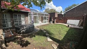 a yard with a large tire in front of a building at The Kempton Star in Kempton Park