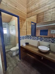 a bathroom with a sink and a toilet at Hotel Isla Gaviota in Tintipan Island