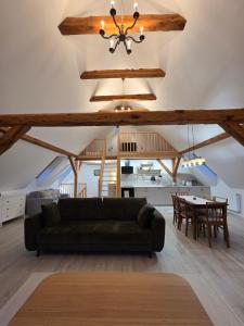 a living room with a couch and a table at Apartament Pod Orzechem in Ulinia