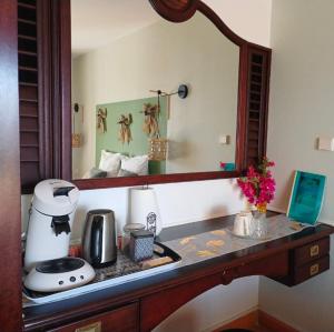 a kitchen counter with a sink and a mirror at Studio vue sur la mer, piscine - L'Oasis de Tartane in La Trinité
