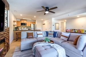 a living room with a couch and a ceiling fan at Sunset Lakefront Retreat with Luxe Upgrades in Osage Beach