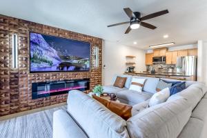 a living room with a couch and a fireplace at Sunset Lakefront Retreat with Luxe Upgrades in Osage Beach +40 photos