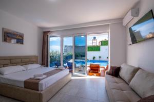 a bedroom with a bed and a couch at Villa Myrtaj - Luxury Private Pool in Sarandë +59 photos