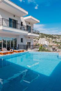 a large swimming pool in front of a house at Villa Myrtaj - Luxury Private Pool in Sarandë