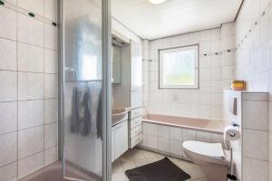 a bathroom with a shower and a toilet and a sink at K8 Living in Wehr