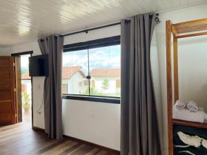 a room with a sliding glass door with a window at Villa Salgueiro in Lavras Novas