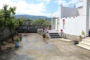 a courtyard of a white building with stairs and plants at Nesti house in Orikum