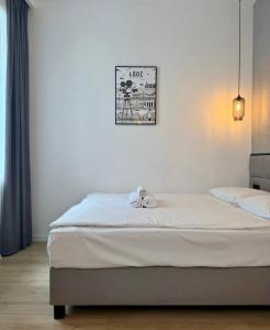 a bedroom with a bed with two towels on it at BOOGIE Home Kamienica Łódzka in Łódź