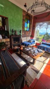 a living room with a couch and a table at El Pedregal Sopó in Sopó