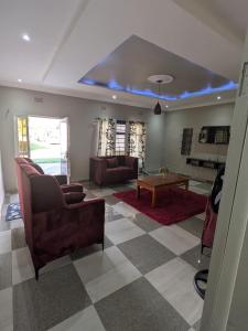 a living room with a couch and a table at Maneya Apartments in Kabwe