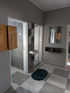 a bathroom with a sink and a mirror at Maneya Apartments in Kabwe