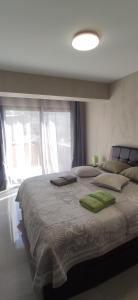 a bedroom with a large bed with a large window at Ocean and Mountain View T2 N-3 in Lazareto