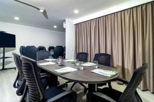 a conference room with a wooden table and chairs at The Morgana Poblado Suites Hotel in Medellín +26 photos
