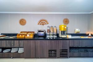 a kitchen with a counter with a coffee maker on it at The Morgana Poblado Suites Hotel in Medellín