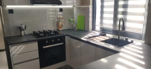a kitchen with a stove and a sink in it at Ocean and Mountain View T2 N-3 in Lazareto +14 photos