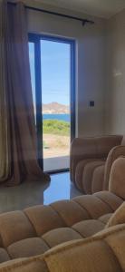 a room with a window with a view of the ocean at Ocean and Mountain View T2 N-3 in Lazareto