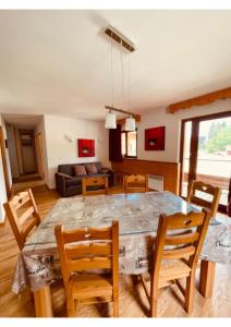 a dining room and living room with a table and chairs at Appartement, 6 pers Casserousse 310 in Chamrousse
