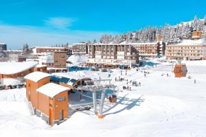 a resort in the snow with people on a ski lift at Appartement, 6 pers Casserousse 310 in Chamrousse