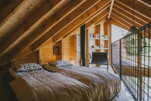 a bedroom with a large bed in a wooden house at Trzy Siostry Udryn in Udryń +84 photos
