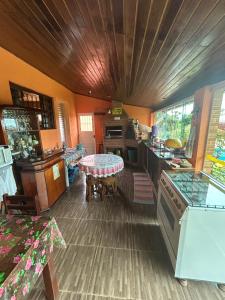 a kitchen with a table in the middle of it at Chalé do Carlos in Ibiúna +2 photos
