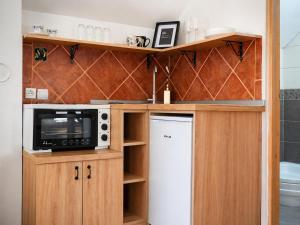 a kitchen with a microwave and a refrigerator at Airport Studio Loft - Galleria in Belgrade