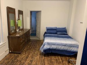 a bedroom with a bed and a dresser and a mirror at The Pearl in Fort Walton Beach