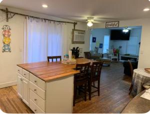 a kitchen and living room with a table and chairs at The Pearl in Fort Walton Beach
