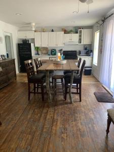 a kitchen with a wooden table and chairs in a room at The Pearl in Fort Walton Beach +6 photos
