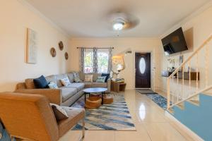 a living room with a couch and a table at Palm Retreat in Ocho Rios