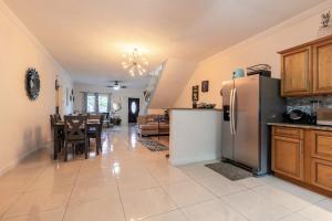 a kitchen and dining room with a refrigerator and a table at Palm Retreat in Ocho Rios