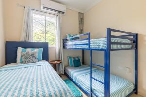 a bedroom with two bunk beds and a window at Palm Retreat in Ocho Rios +27 photos