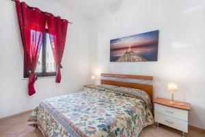 a bedroom with a bed and two windows at Casa Sciura in San Vito lo Capo +13 photos