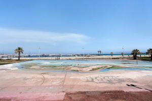 a park with a painting on it next to the beach at Casa Sciura in San Vito lo Capo
