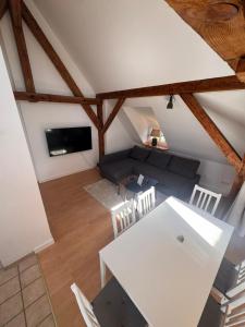 a living room with a couch and a table and chairs at Bavaria Home Kitchen Parks No 5 in Geisenfeld