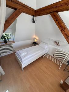 a white bed in a room with a wooden ceiling at Bavaria Home Kitchen Parks No 5 in Geisenfeld +12 photos