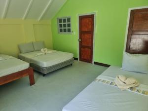 a room with two beds and a chair and a door at Rancho Primavera in Cuatro Esquinas +9 photos