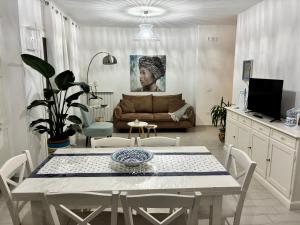 a living room with a table and a couch at Astrea Apartament in Tropea