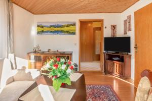 a living room with a couch and a tv at Haus Schmucker in Hohekreuz