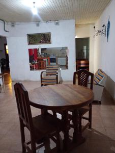 a dining room with a wooden table and chairs at Alojamiento Ceibo en Flor in Esquina