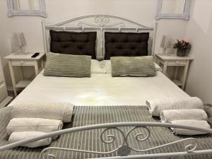 a bedroom with a large bed with two night stands at Astrea Apartament in Tropea +28 photos