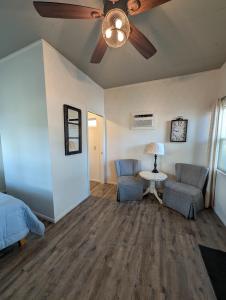 a bedroom with two chairs and a ceiling fan at Cozy Cabin in Squaw Valley