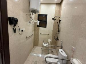 a bathroom with a toilet and a phone in it at الجوهرة بارك للشقق المخدومة 7 in Riyadh