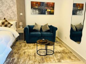 a bedroom with a bed and a couch and a table at AccraAura-Airport Residential in Accra +23 photos