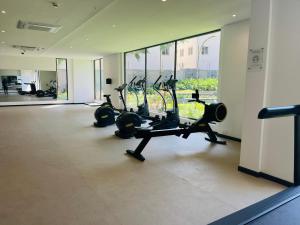 a gym with treadmills and ellipticals in a building at AccraAura-Airport Residential in Accra