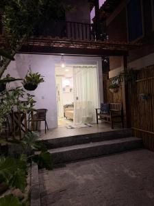 a patio with stairs leading to a door with a couch at Loft Itacoatiara in Niterói