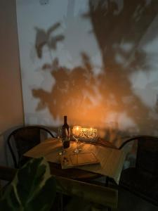 a table with a bottle of wine and candles on it at Loft Itacoatiara in Niterói +54 photos