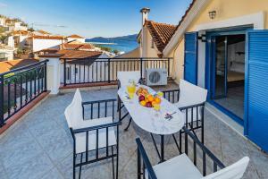 a patio with a table and chairs on a balcony at VERANDA MARE in Agia Effimia
