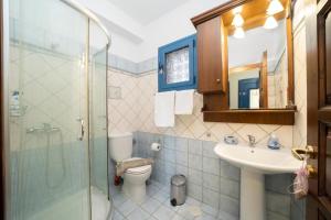 a bathroom with a toilet and a sink and a shower at VERANDA MARE in Agia Effimia +58 photos