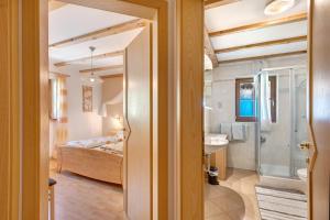 a bathroom with a bed and a sink in a room at Grafaierhof in Kastelruth +103 photos